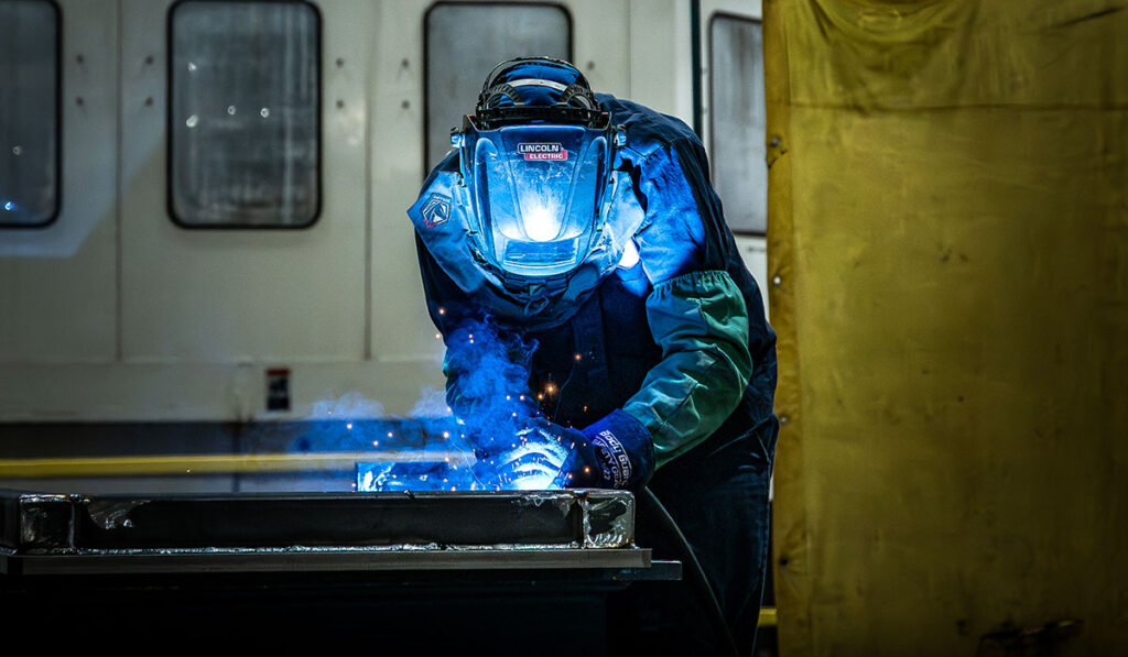 Anchor employee welding in facility